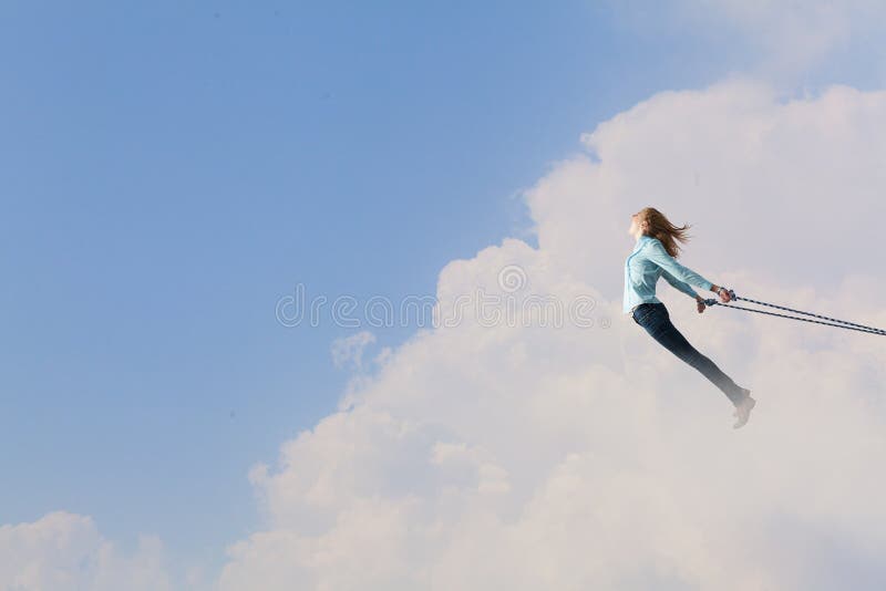 Young girl with ropes on hands trying to fly. Young girl with ropes on hands trying to fly