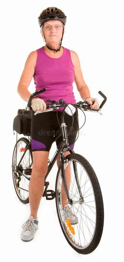Isolated on white, a fit senior woman is riding a bicycle. Isolated on white, a fit senior woman is riding a bicycle.