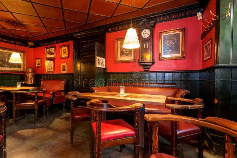 COPENHAGEN, DENMARK - SEPT 5: Cozy bar interior waiting for drinkers inside vintage room with classic style tables and chairs on 5 September, 2018. Copenhagen has population near 1.3 million. COPENHAGEN, DENMARK - SEPT 5: Cozy bar interior waiting for drinkers inside vintage room with classic style tables and chairs on 5 September, 2018. Copenhagen has population near 1.3 million