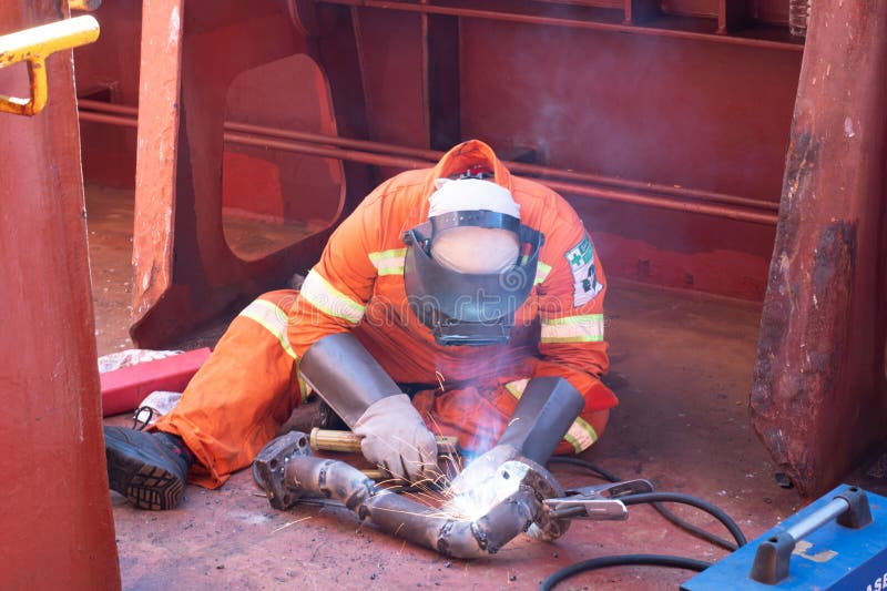 welder of ship fabricating a damage pipe line by welding. welder of ship fabricating a damage pipe line by welding