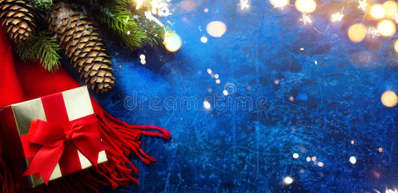 Merry and Bright Christmas and Happy New Year greeting card holidays backdropwith Christmas Tree Decorations and Holiday Gift on Blue Background. Merry and Bright Christmas and Happy New Year greeting card holidays backdropwith Christmas Tree Decorations and Holiday Gift on Blue Background