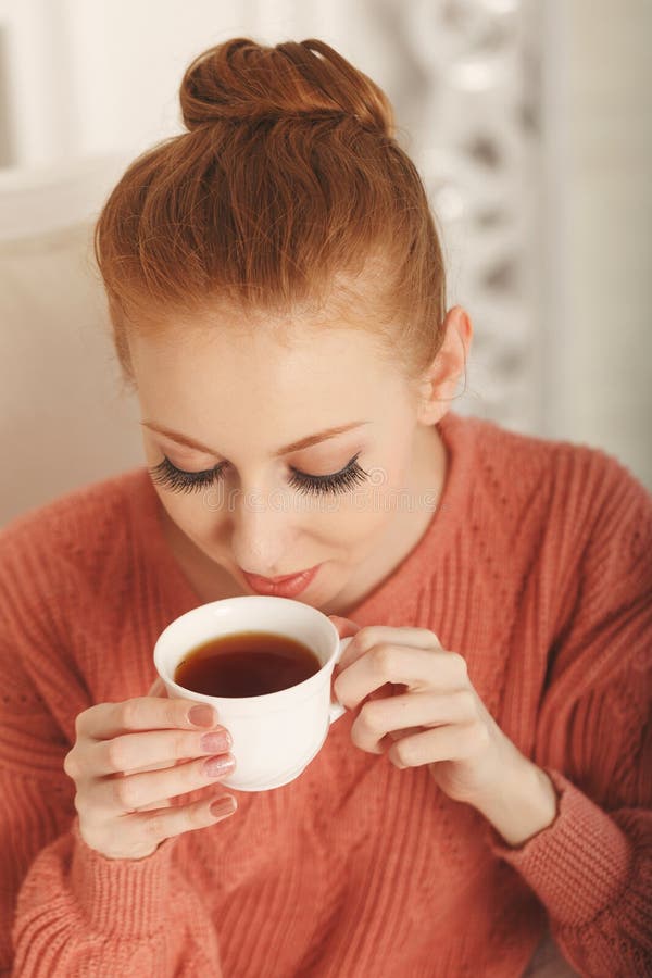 Pretty young ballerina tea drinkers. Close-up portrait. The girl in the pink sweater. Pretty young ballerina tea drinkers. Close-up portrait. The girl in the pink sweater