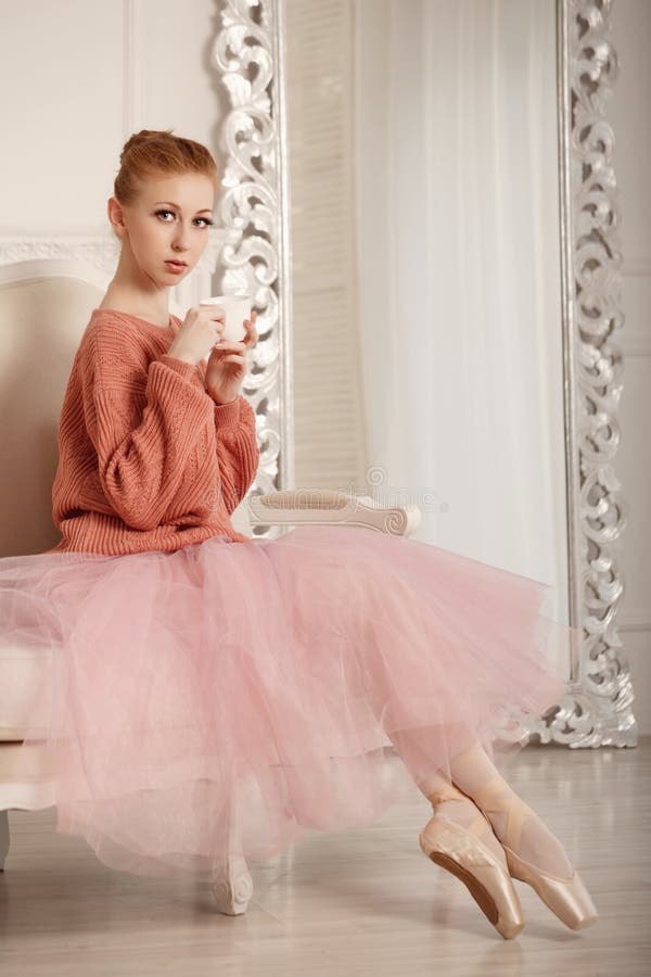 Pretty young ballerina tea drinkers. Ballerina in tutu and pink sweater. Time to drink tea. Pretty young ballerina tea drinkers. Ballerina in tutu and pink sweater. Time to drink tea.