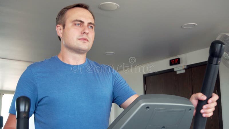 英俊的做在省略教练员的健身房的适合嬉戏正面年轻人锻炼解决 股票视频