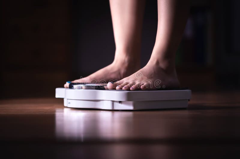 英尺缩放比例 减重和饮食概念 称妇女的她自己 健身夫人节食 Weightloss和营养学 免版税库存照片