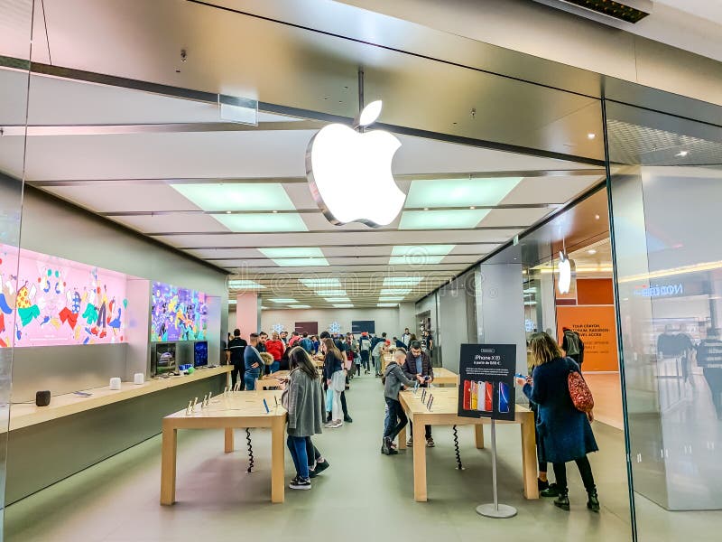 LYON, FRANCE - FEBRUARY 27, 2019: Apple store of American multinational technology company brand logo at its shop located in Lyon shopping mall France. Mobile photo. LYON, FRANCE - FEBRUARY 27, 2019: Apple store of American multinational technology company brand logo at its shop located in Lyon shopping mall France. Mobile photo