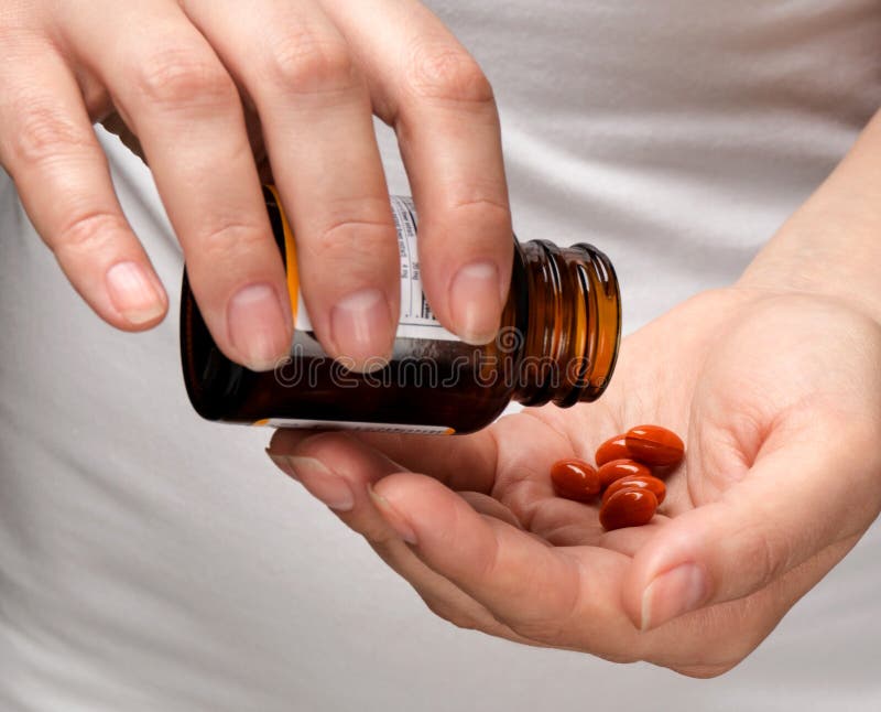 Women's hands holding pills and a tube. Women's hands holding pills and a tube