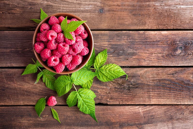 Raspberry with leaves in a bowl. Raspberry with leaves in a bowl