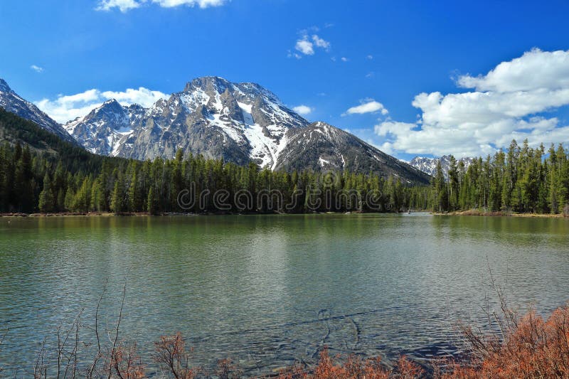 Mount Moran dominates the landscape of the Rocky Mountains behind the clear waters of the glacial String Lake that connects Leigh and Jenny Lakes, Grand Teton National Park, Wyoming, USA. Mount Moran dominates the landscape of the Rocky Mountains behind the clear waters of the glacial String Lake that connects Leigh and Jenny Lakes, Grand Teton National Park, Wyoming, USA.