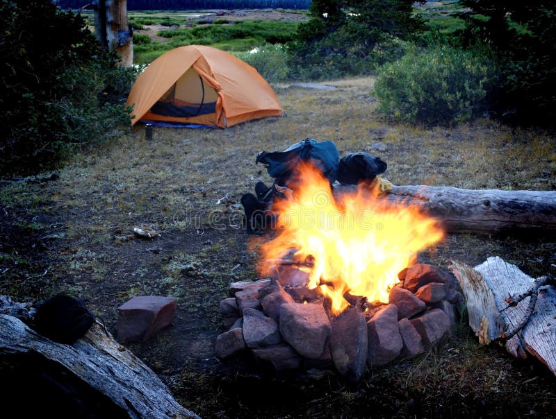 Campfire with tent in background for camping scene. Campfire with tent in background for camping scene