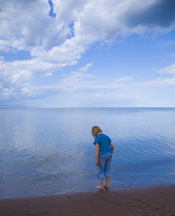 Blue child, sky, and water on the Wisconsin shore of Lake Superior. Blue child, sky, and water on the Wisconsin shore of Lake Superior