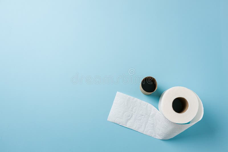 Top view of toilet paper roll on blue background. Top view of toilet paper roll on blue background.