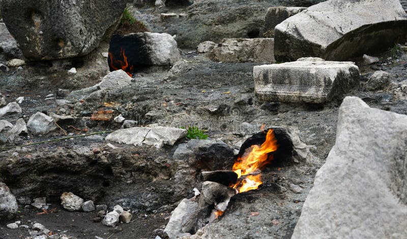 Cirali, Antalya/Turkey-January 01, 2018: Chimera, burning rocks are remarkable spot ot the trail of Lycian way near Cirali, Antalya. Cirali, Antalya/Turkey-January 01, 2018: Chimera, burning rocks are remarkable spot ot the trail of Lycian way near Cirali, Antalya