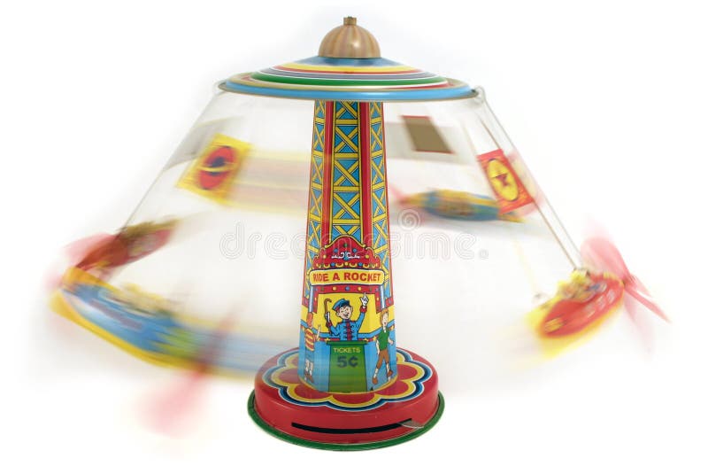 Antique tin toy of a carnival rocket ride that shows the rockets spinning in motion. Antique tin toy of a carnival rocket ride that shows the rockets spinning in motion.