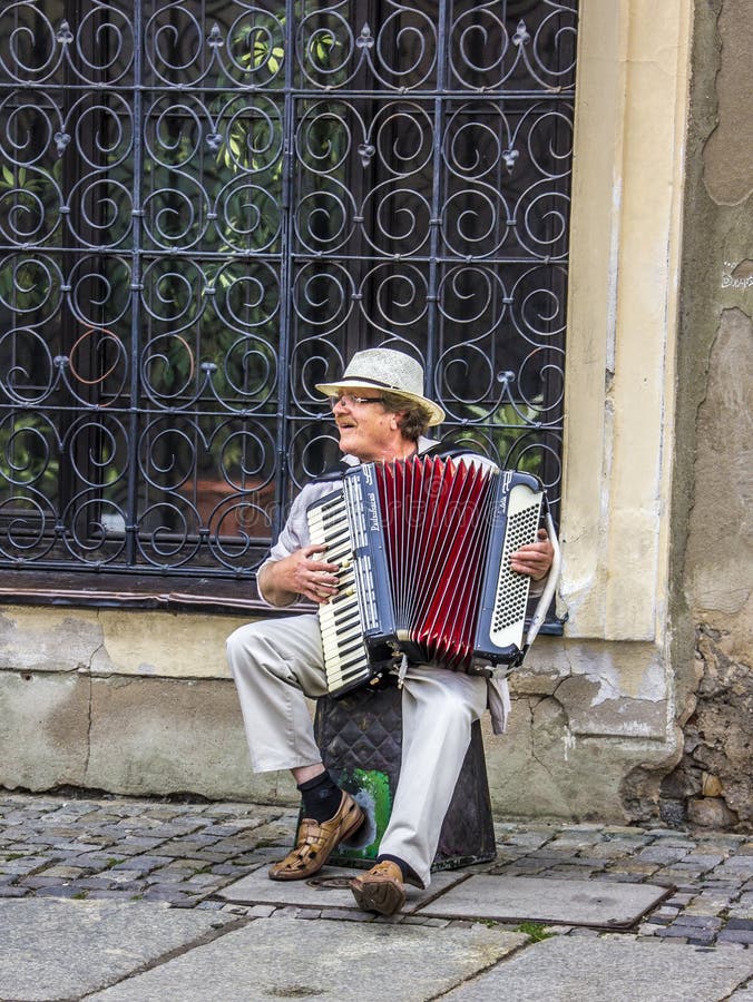 A street musician at the old market of Poznan, Poland. The market is from the the 16th century. A street musician at the old market of Poznan, Poland. The market is from the the 16th century.