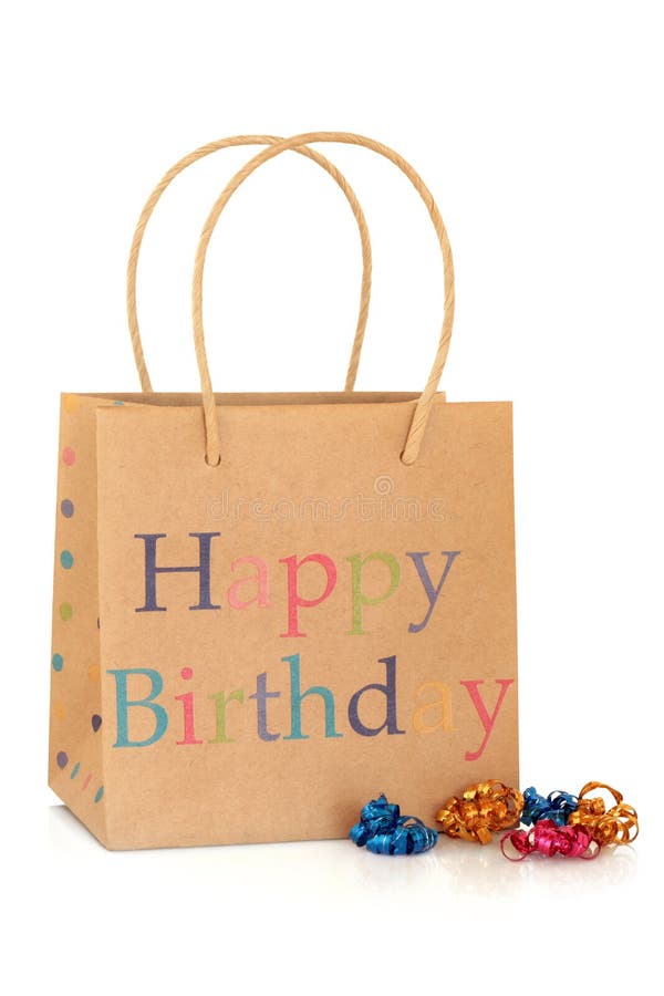 Happy birthday gift bag made of recycled paper, with coloured curly ribbons, isolated over white background. Happy birthday gift bag made of recycled paper, with coloured curly ribbons, isolated over white background.