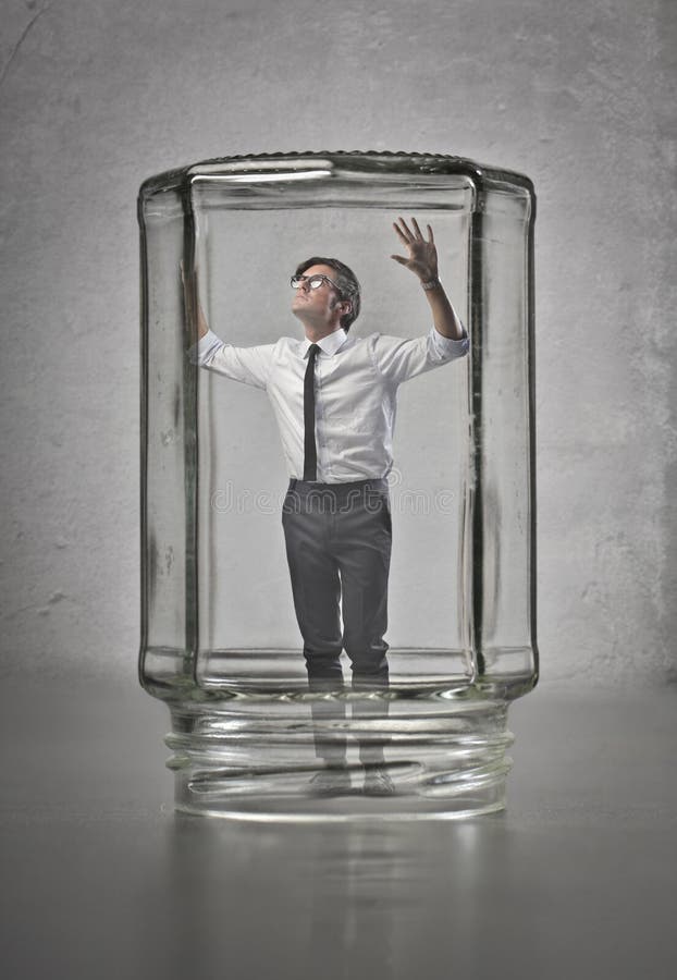 Businessman trapped in glass container. Businessman trapped in glass container