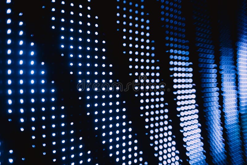 Photo of halftone blue blurred led lights in the night club darkness. Photo of halftone blue blurred led lights in the night club darkness