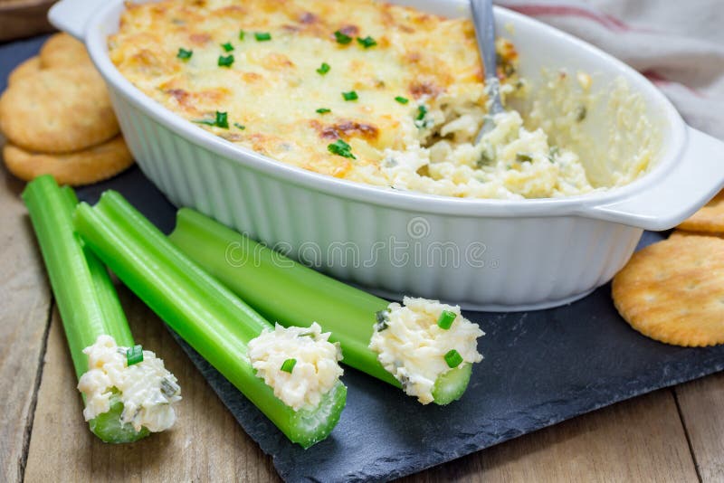 Baked crab dip, served with celery sticks, crackers. Baked crab dip, served with celery sticks, crackers