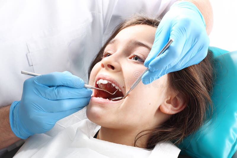 Child in the dental chair dental treatment during surgery. Child in the dental chair dental treatment during surgery.