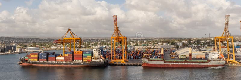 Bridgetown port, Barbados, West Indies - May 2, 2020: Bridgetown port with loading cranes and cargo ships being loaded with containers. Bridgetown port, Barbados, West Indies - May 2, 2020: Bridgetown port with loading cranes and cargo ships being loaded with containers