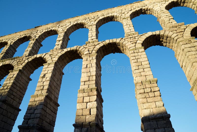 View from below the Roman aqueduct in the city of Segovia, Castilla Leon in Spain. View from below the Roman aqueduct in the city of Segovia, Castilla Leon in Spain