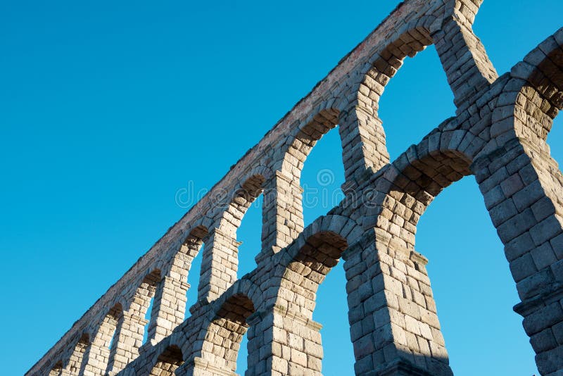 View from below the Roman aqueduct in the city of Segovia, Castilla Leon in Spain. View from below the Roman aqueduct in the city of Segovia, Castilla Leon in Spain