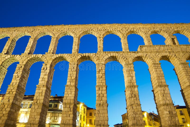 Night view from below the Roman aqueduct in the city of Segovia, Castilla Leon in Spain. Night view from below the Roman aqueduct in the city of Segovia, Castilla Leon in Spain