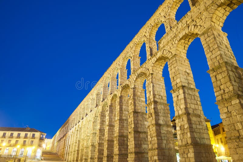 Night view from below the Roman aqueduct in the city of Segovia, Castilla Leon in Spain. Night view from below the Roman aqueduct in the city of Segovia, Castilla Leon in Spain