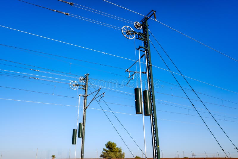 Towers of the electrified catenaries of a high-speed train in Spain. Towers of the electrified catenaries of a high-speed train in Spain.