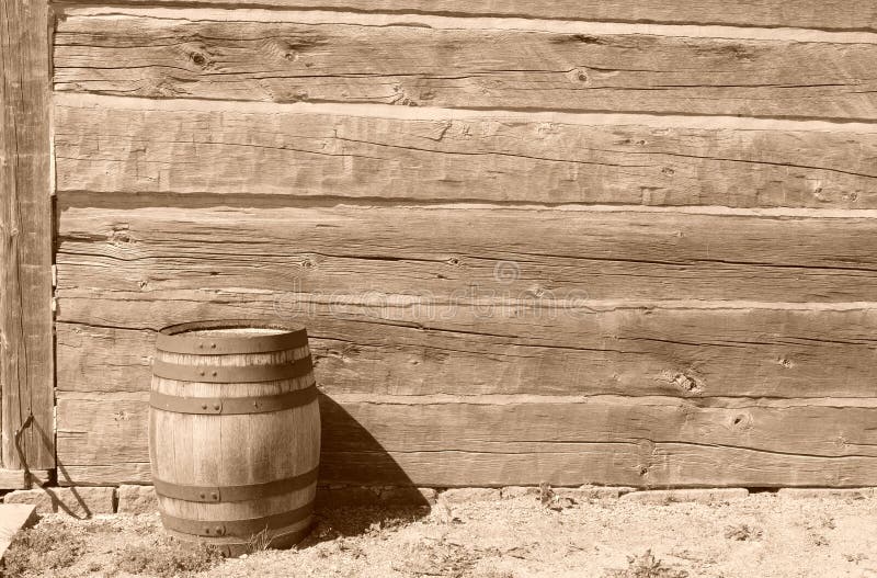 A sepia image of a barrel in front of a worn down building. The sepia effect conveys an old way of life. It is intended to be used as a backdrop. A sepia image of a barrel in front of a worn down building. The sepia effect conveys an old way of life. It is intended to be used as a backdrop.