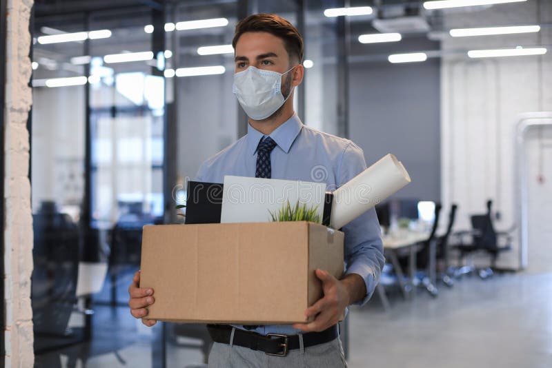 Dismissal employee in an epidemic coronavirus. Dismissed worker going from the office with his office supplies. Dismissal employee in an epidemic coronavirus. Dismissed worker going from the office with his office supplies.