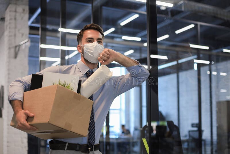 Dismissal employee in an epidemic coronavirus. Dismissed worker going from the office with his office supplies. Dismissal employee in an epidemic coronavirus. Dismissed worker going from the office with his office supplies.