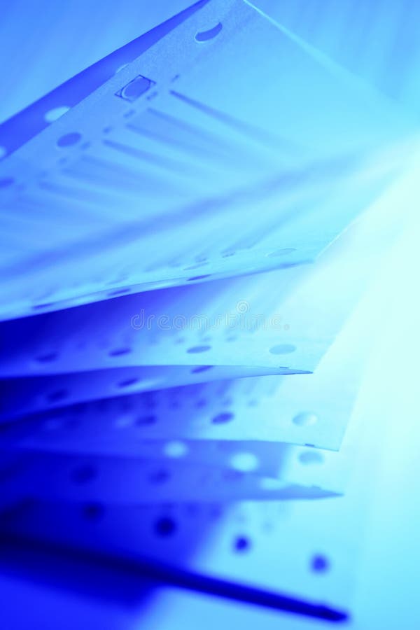 Closeup of computer printer paper sheets folded on it's side, with blue lighting. Closeup of computer printer paper sheets folded on it's side, with blue lighting.