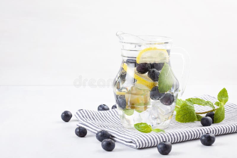 Herbs and fruits flavored infused water. Summer refreshing drink. Health care, fitness, healthy nutrition diet concept. Herbs and fruits flavored infused water. Summer refreshing drink. Health care, fitness, healthy nutrition diet concept.