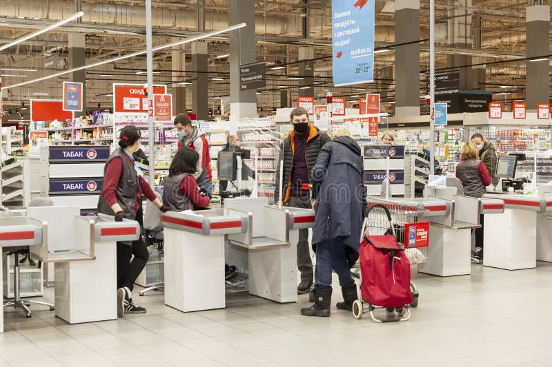 Drinkers and masked workers at the checkout counters in the supermarket. Moscow, Russia, 03-31-2021. Drinkers and masked workers at the checkout counters in the supermarket. Moscow, Russia, 03-31-2021.