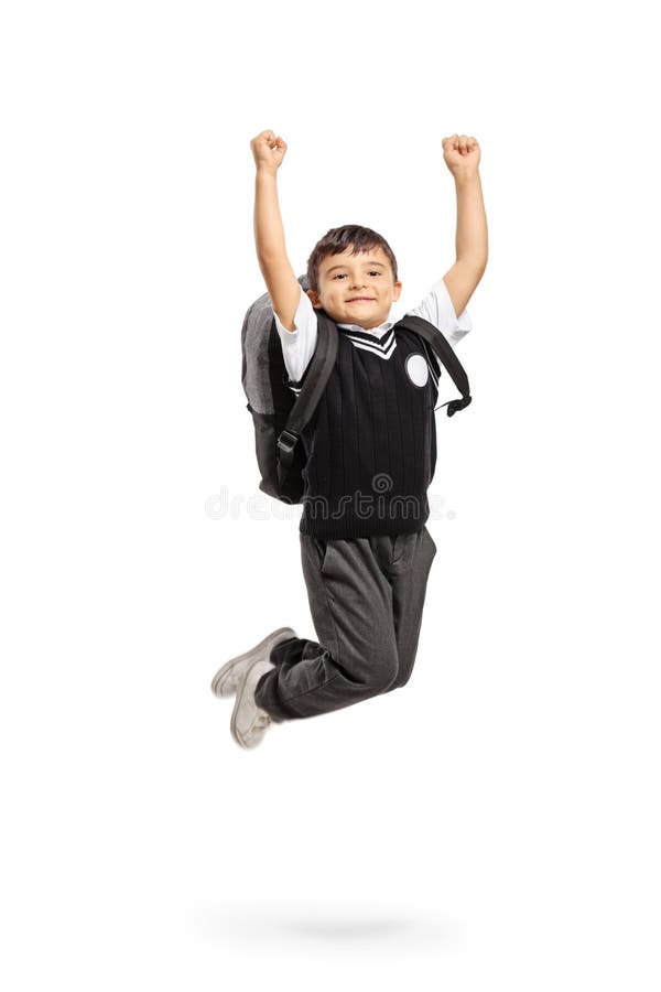 跳跃和打手势幸福的极度高兴的男小学生