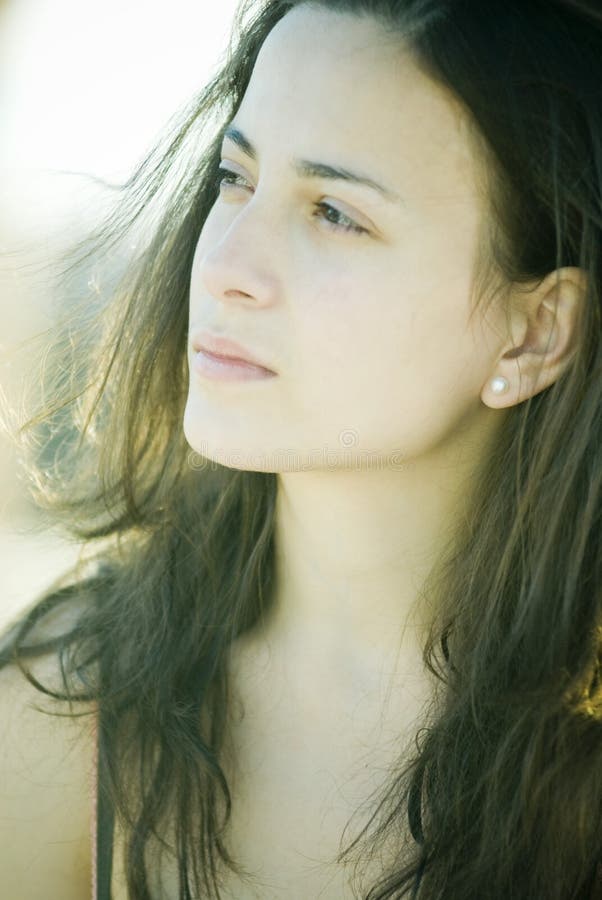 A young woman photographed under soft lighting. A young woman photographed under soft lighting.