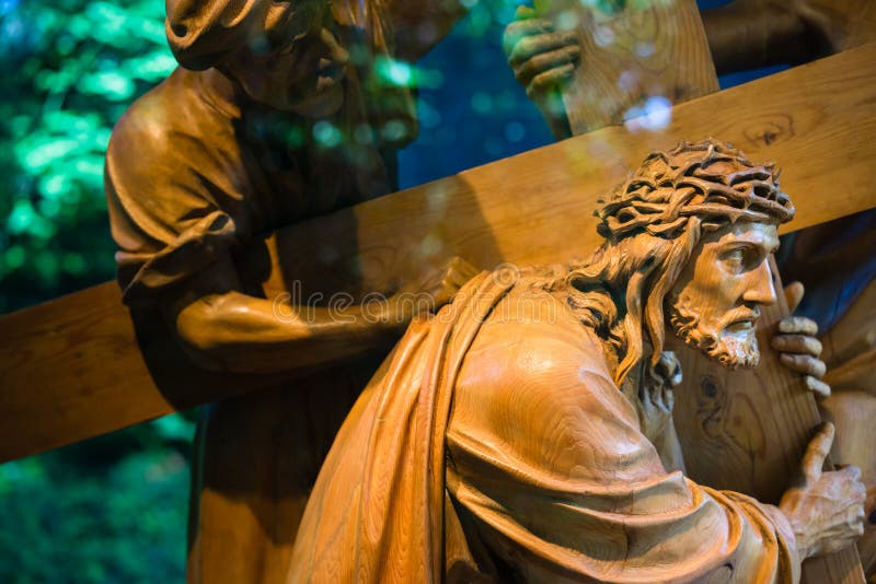 Wooden carving of Jesus wearing a crown of thorns carrying the cross. Wooden carving of Jesus wearing a crown of thorns carrying the cross