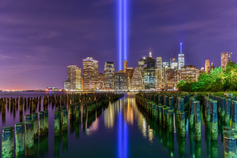 New York City Manhattan downtown skyline at night with the Tribute in Light in memory of September 11. New York City Manhattan downtown skyline at night with the Tribute in Light in memory of September 11.