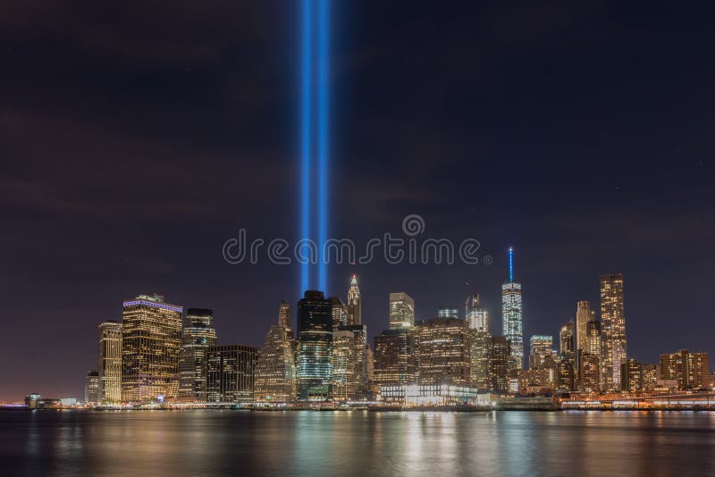 New York City Manhattan downtown skyline at night with the Tribute in Light in memory of September 11. New York City Manhattan downtown skyline at night with the Tribute in Light in memory of September 11.