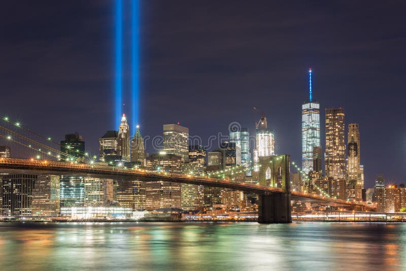 New York City Manhattan downtown skyline at night with the Tribute in Light in memory of September 11. New York City Manhattan downtown skyline at night with the Tribute in Light in memory of September 11.