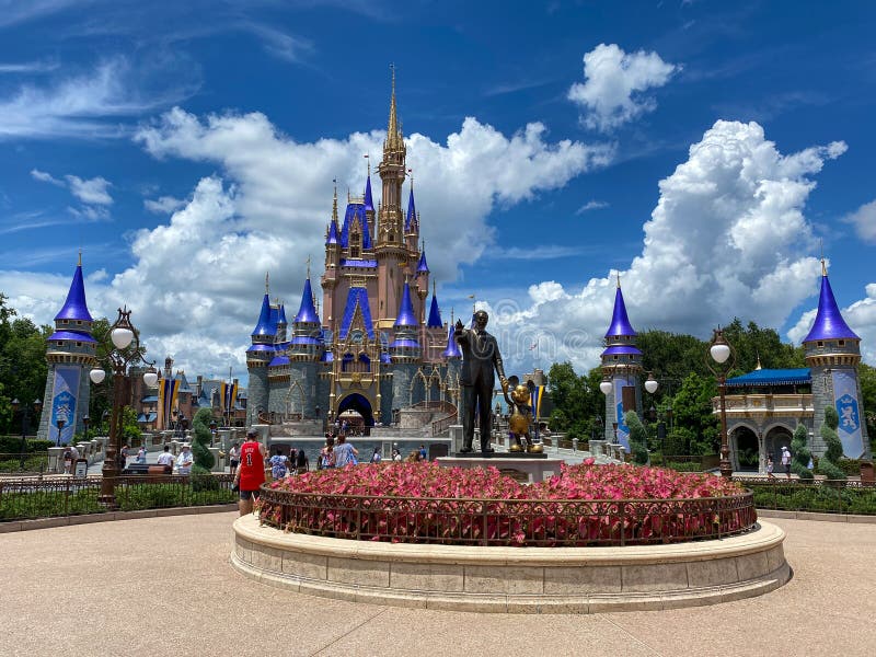 Orlando,FL/USA- 7/25/20: The Walt Disney and Mickey Mouse partner statue in front of Cinderella`s castle in Magic Kingdom at Walt Disney World in Orlando, Florida. Orlando,FL/USA- 7/25/20: The Walt Disney and Mickey Mouse partner statue in front of Cinderella`s castle in Magic Kingdom at Walt Disney World in Orlando, Florida