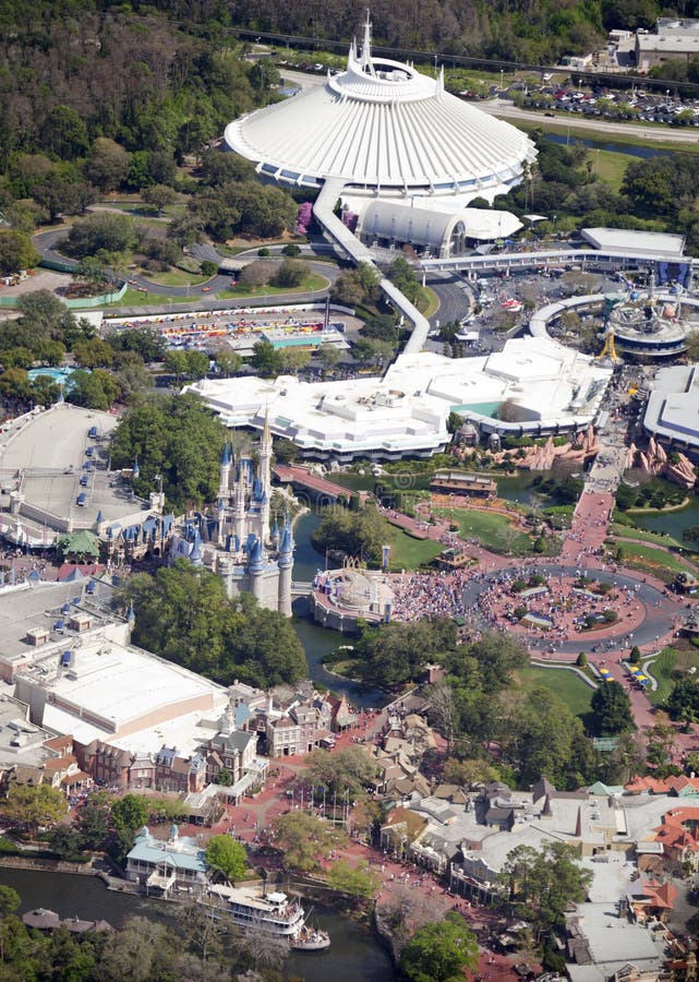 Aerial view of Walt Disney Worlds Magic Kingdom, in Lake Buena Vista, Florida. Tourists are shown enjoying a beautiful day at the theme park. Cinderellas castle (center left) , Tomorrowland s Space Mountain (top center) and Frountierland with Mark Twains riverboat ride at the bottom. Aerial view of Walt Disney Worlds Magic Kingdom, in Lake Buena Vista, Florida. Tourists are shown enjoying a beautiful day at the theme park. Cinderellas castle (center left) , Tomorrowland s Space Mountain (top center) and Frountierland with Mark Twains riverboat ride at the bottom.