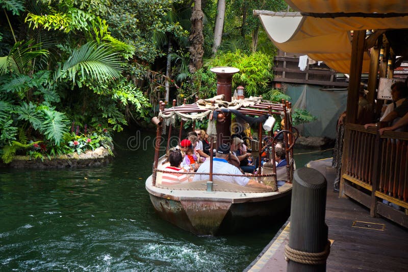 Tourists settle into the tour boat ride through Walt Disney`s Jungle Cruise. Location Anaheim, CA at Disneyland in the Adventureland section of the amusement park. Tourists settle into the tour boat ride through Walt Disney`s Jungle Cruise. Location Anaheim, CA at Disneyland in the Adventureland section of the amusement park.