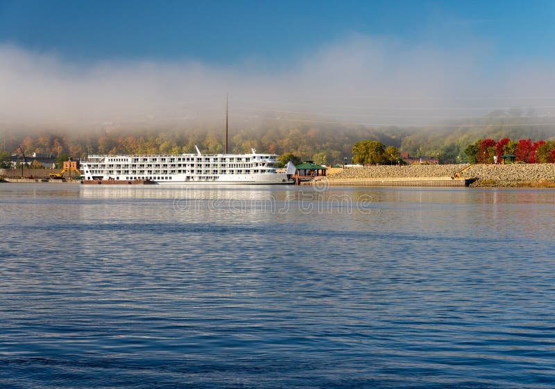 Upper Mississippi on calm misty morning at Dubuque with docked river cruise boat. Upper Mississippi on calm misty morning at Dubuque with docked river cruise boat