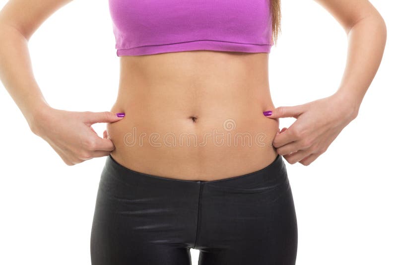 Closeup of fit young woman pinching fat on her waist. Pot belly or love handles. Isolated on white background. Closeup of fit young woman pinching fat on her waist. Pot belly or love handles. Isolated on white background.