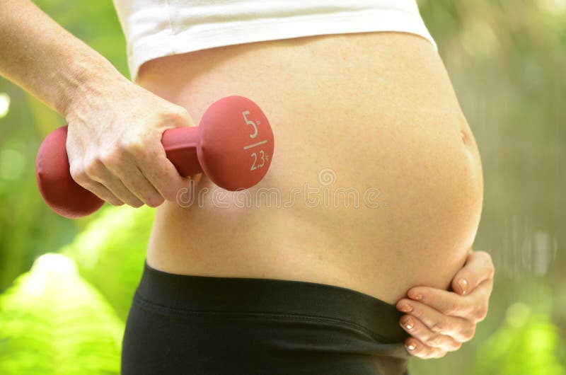 Woman working out while pregnant for a fit pregnancy. Woman working out while pregnant for a fit pregnancy