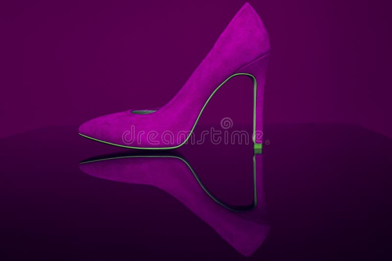 Shoe on a transparent surface. Advertising seductive shoes for sexy girls. Shop shoes. Evening shoes for theater, restaurant and cinema. Stylish girl and choice of shoes. Violet purple color close-up. Shoe on a transparent surface. Advertising seductive shoes for sexy girls. Shop shoes. Evening shoes for theater, restaurant and cinema. Stylish girl and choice of shoes. Violet purple color close-up