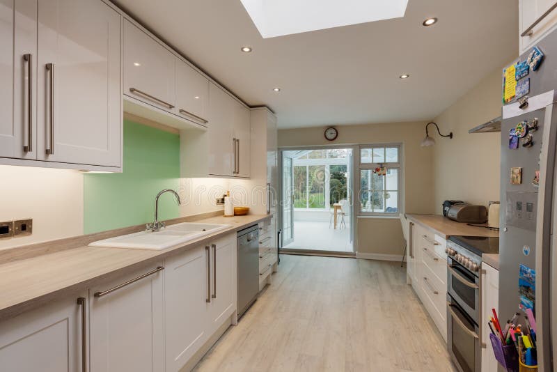 Great Shelford, Cambridgeshire - Jan 2 2019: Fitted kitchen with doors open to upvc conservatory. Great Shelford, Cambridgeshire - Jan 2 2019: Fitted kitchen with doors open to upvc conservatory